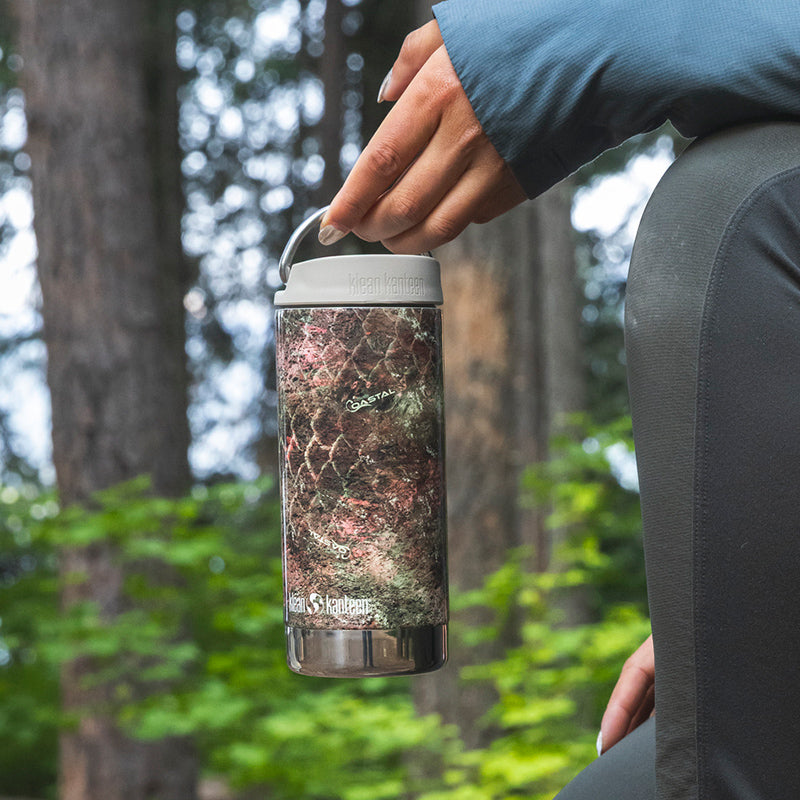 12oz-tkwide-with-cafe-cap-mossy-oak-x0 12oz_tumbler_mossyoak_rainbowtrout_hand_closeup_square.jpg