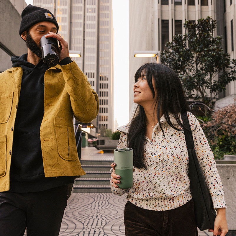 16oz-rise-tumbler-h4 16oz_rise_tumbler_black_iceberg_couple_drink_city_street_square.jpg